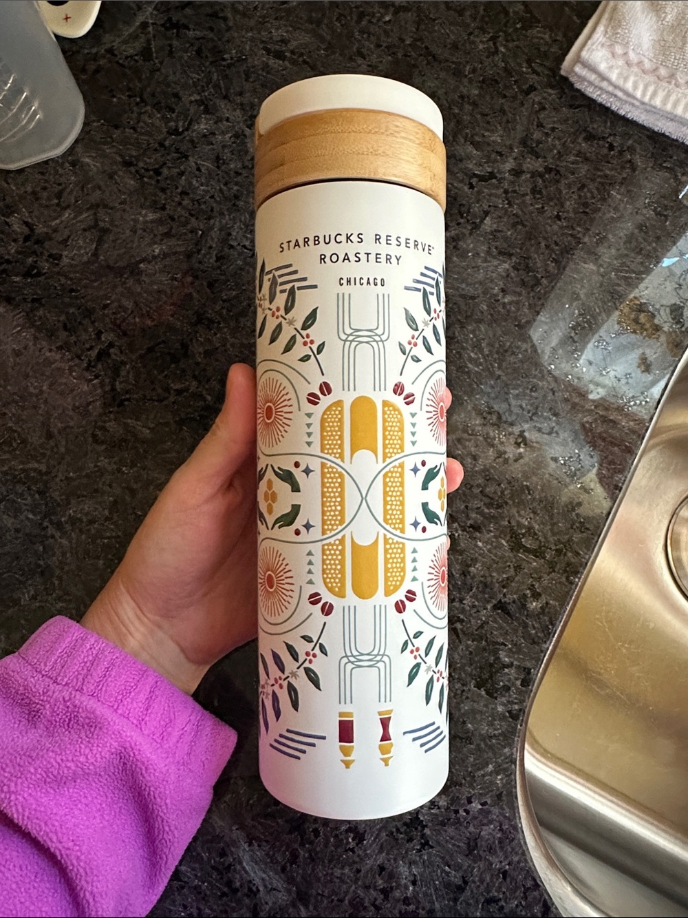 Starbucks white travel tumbler with wood-tone lid and floral pattern